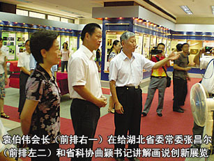 袁伯偉會長（前排右一）在給湖北省委常委張昌爾（前排左二）和省科協(xié)曲穎書記講解畫說創(chuàng)新展覽